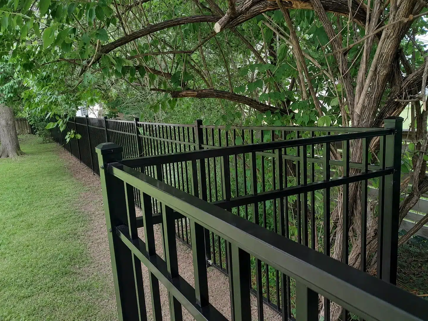 Corner section of a 54-inch three-rail black aluminum fence installation in Severna Park, MD.