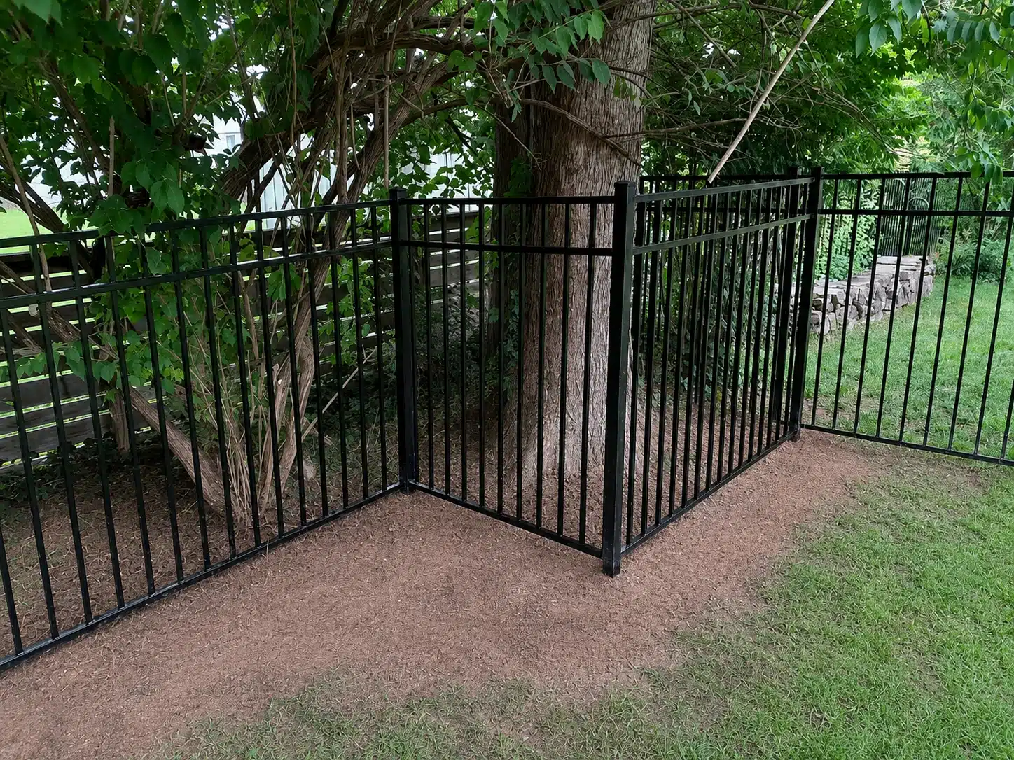 54-inch three-rail aluminum fence built around mature trees in a Severna Park, MD backyard.