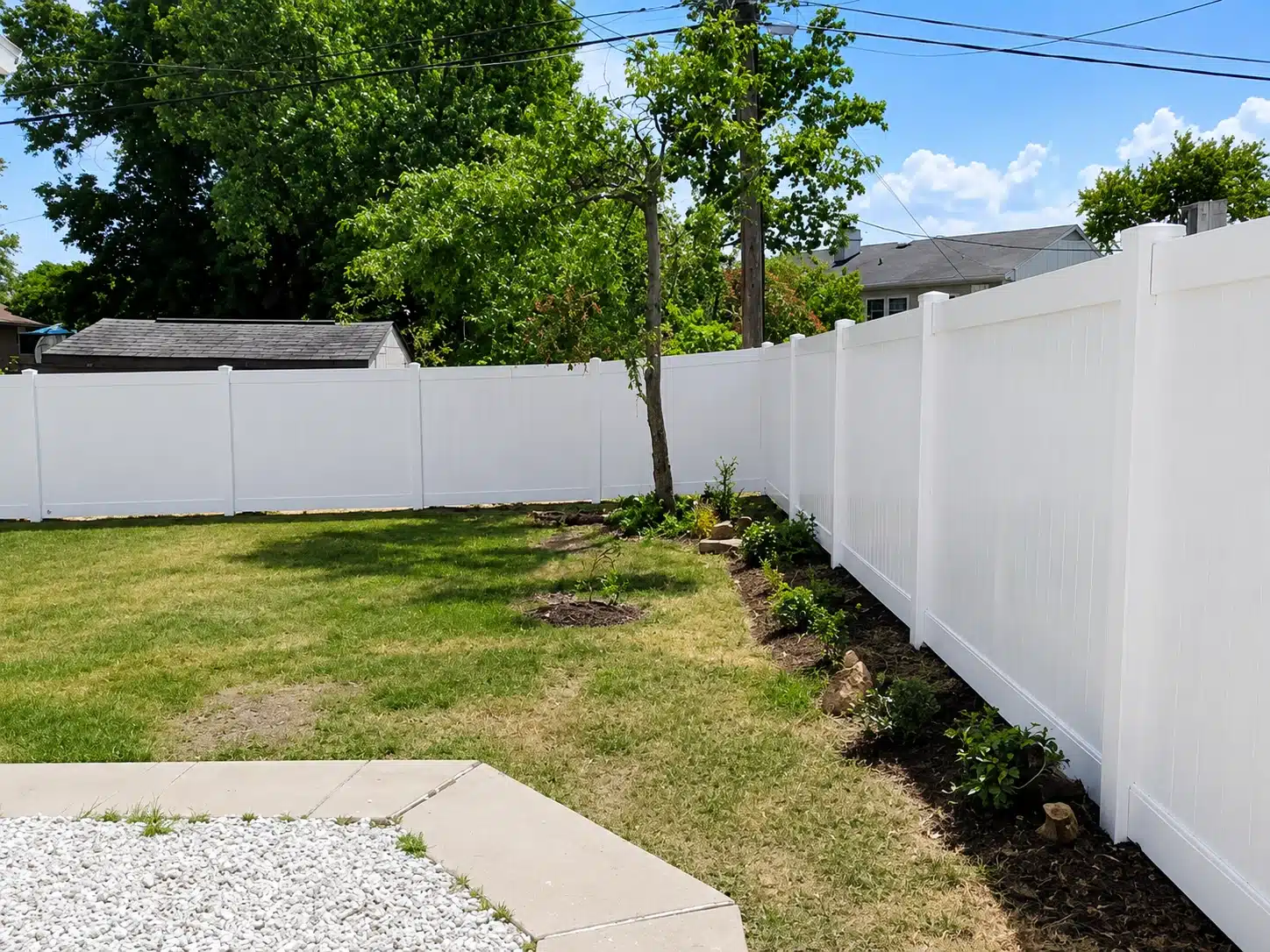 White vinyl privacy fence surrounding a residential backyard in Ferndale, MD