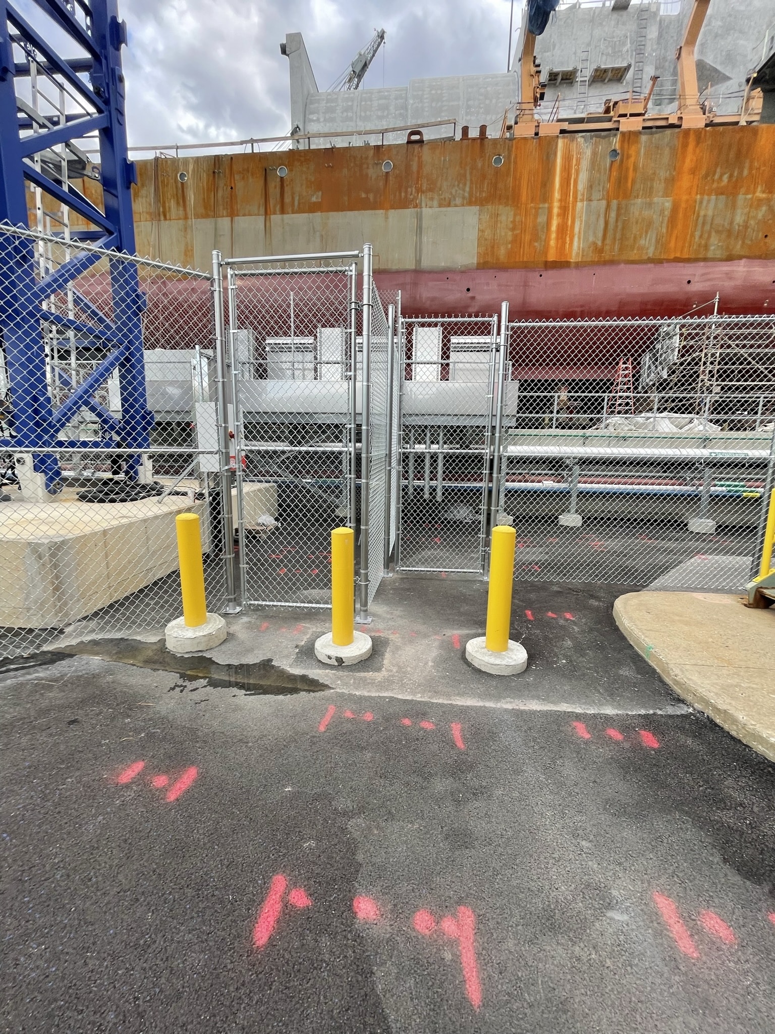 Controlled-access chain link fencing with secure entry points at an industrial site