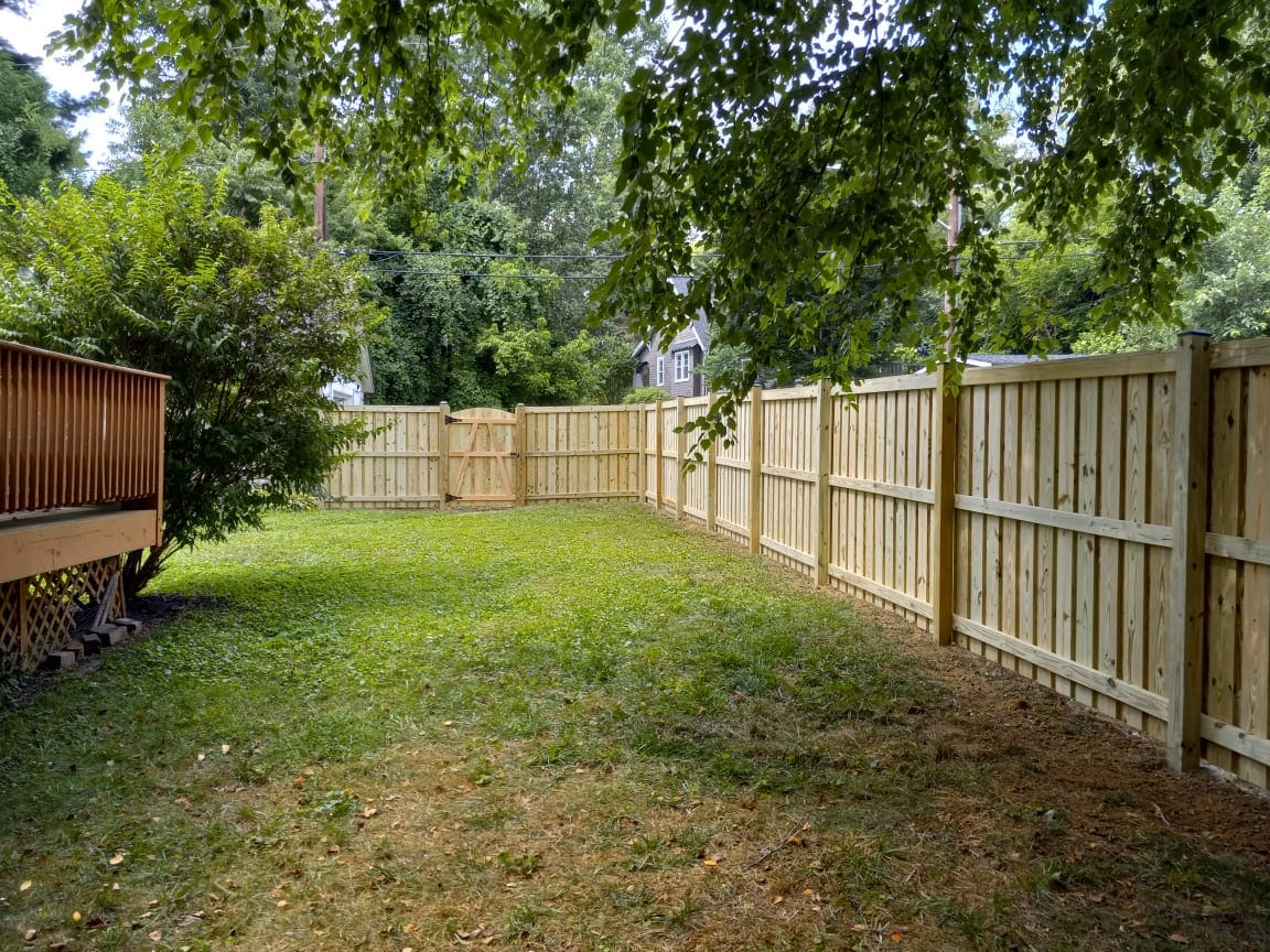 clean pressure-treated plank fence running along a residential property in Severna Park MD