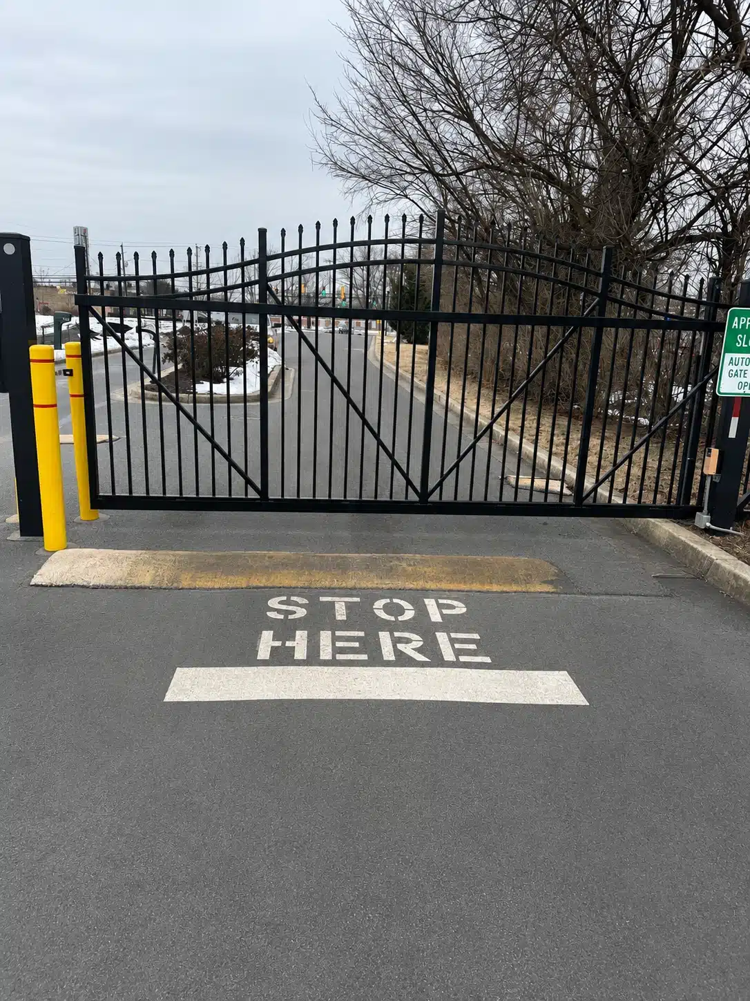 Automated apartment entry slide gate with black metal panels and access control in Severna Park.