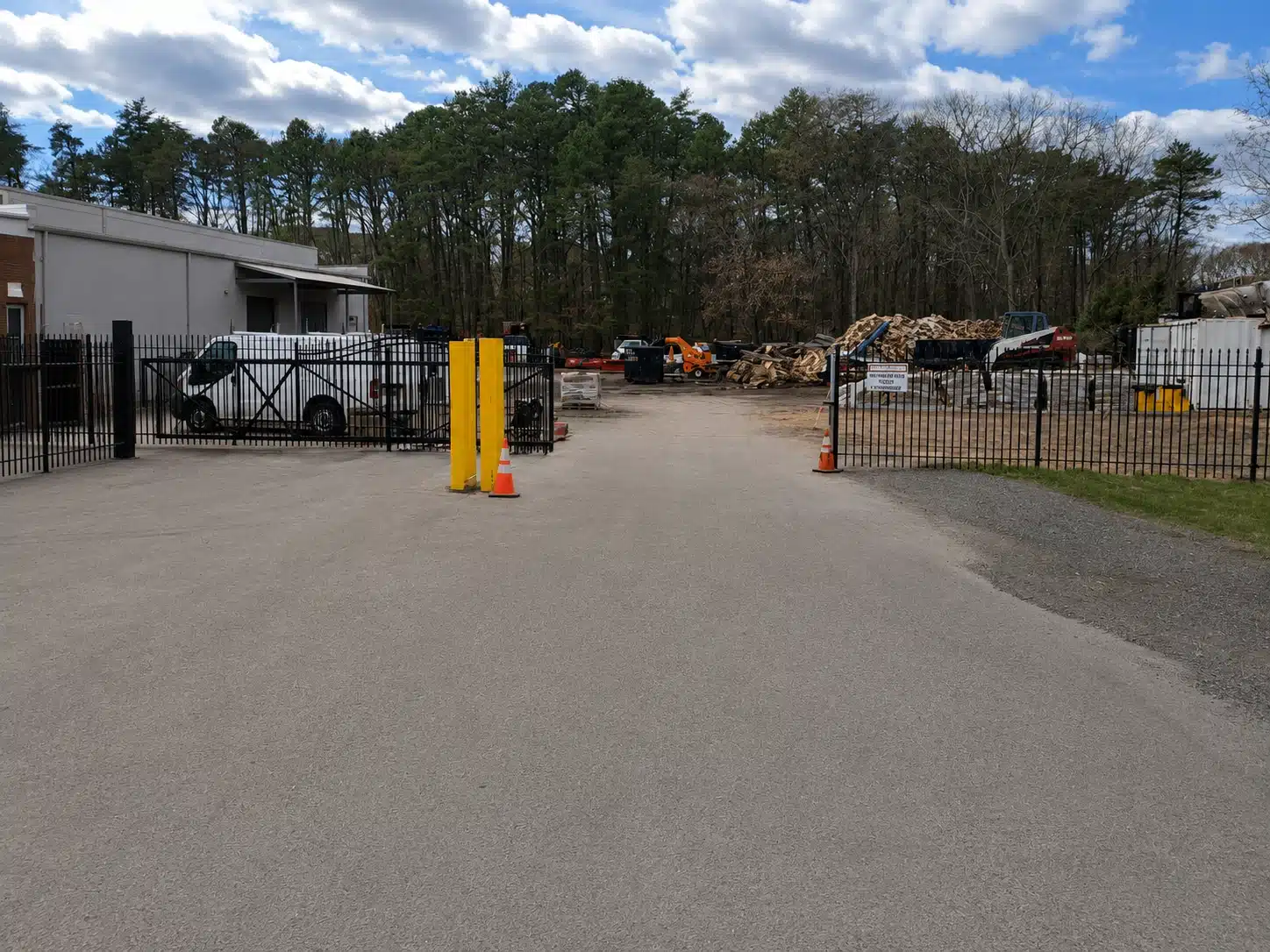 Automated industrial yard gate with black metal fencing and access control in Severna Park.