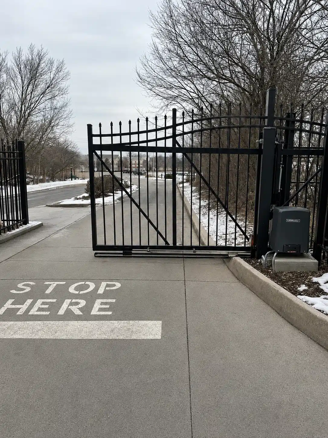 Automated sliding security gate at a commercial entrance during winter in Severna Park.