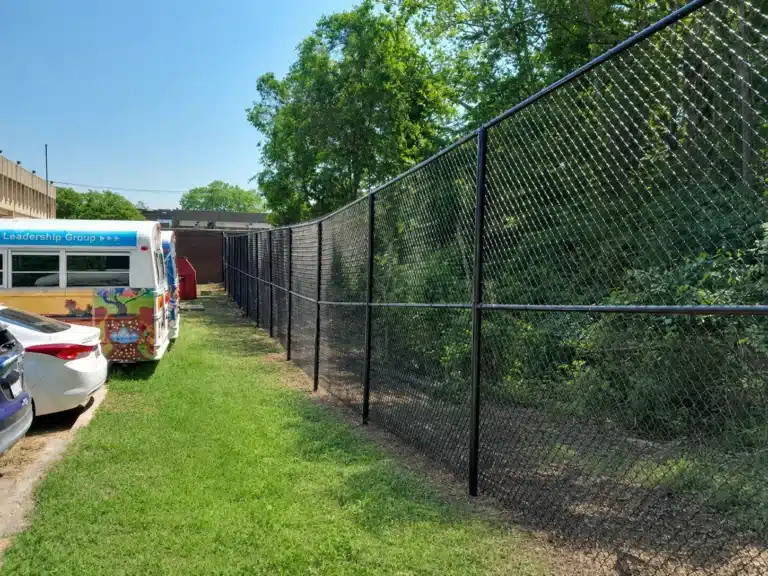 Black chain-link commercial fence installed along a roadside lot in Severna Park.