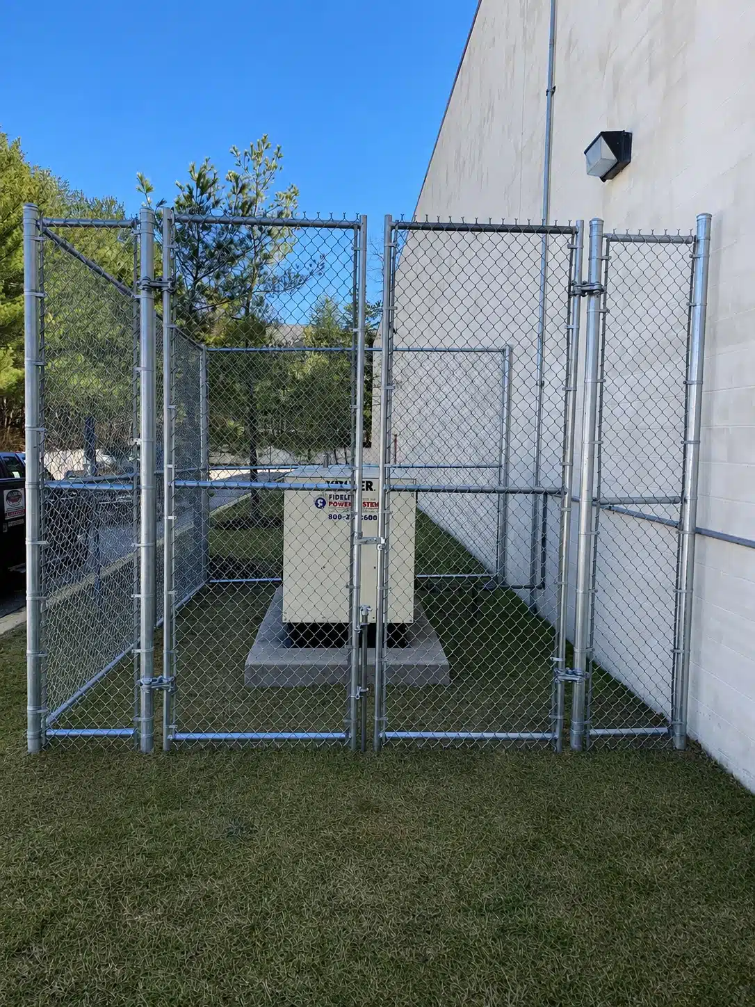 Galvanized chain-link fence enclosure protecting commercial generator equipment in Severna Park.