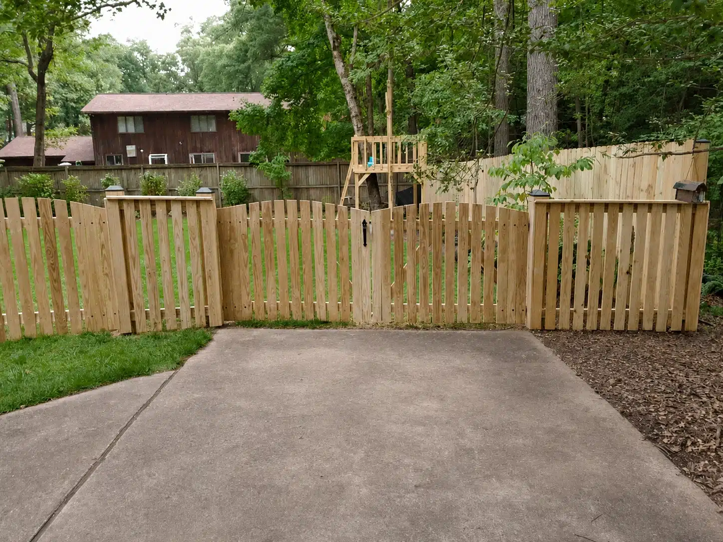 Custom wood backyard gate with matching fence panels in Severna Park, MD.