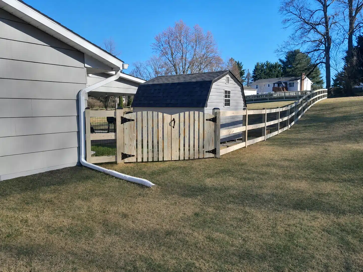 Wood farm-style gate with matching fence along a residential yard in Severna Park, MD.