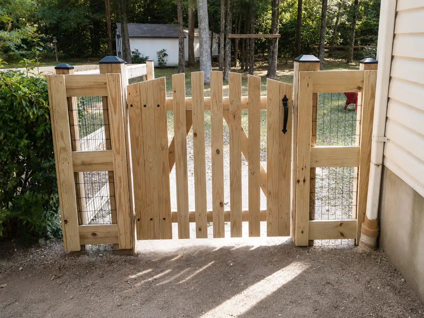 Custom wood picket gate with wire side panels for a backyard in Severna Park, MD.