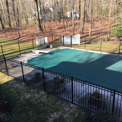 wrought iron fence around a covered pool