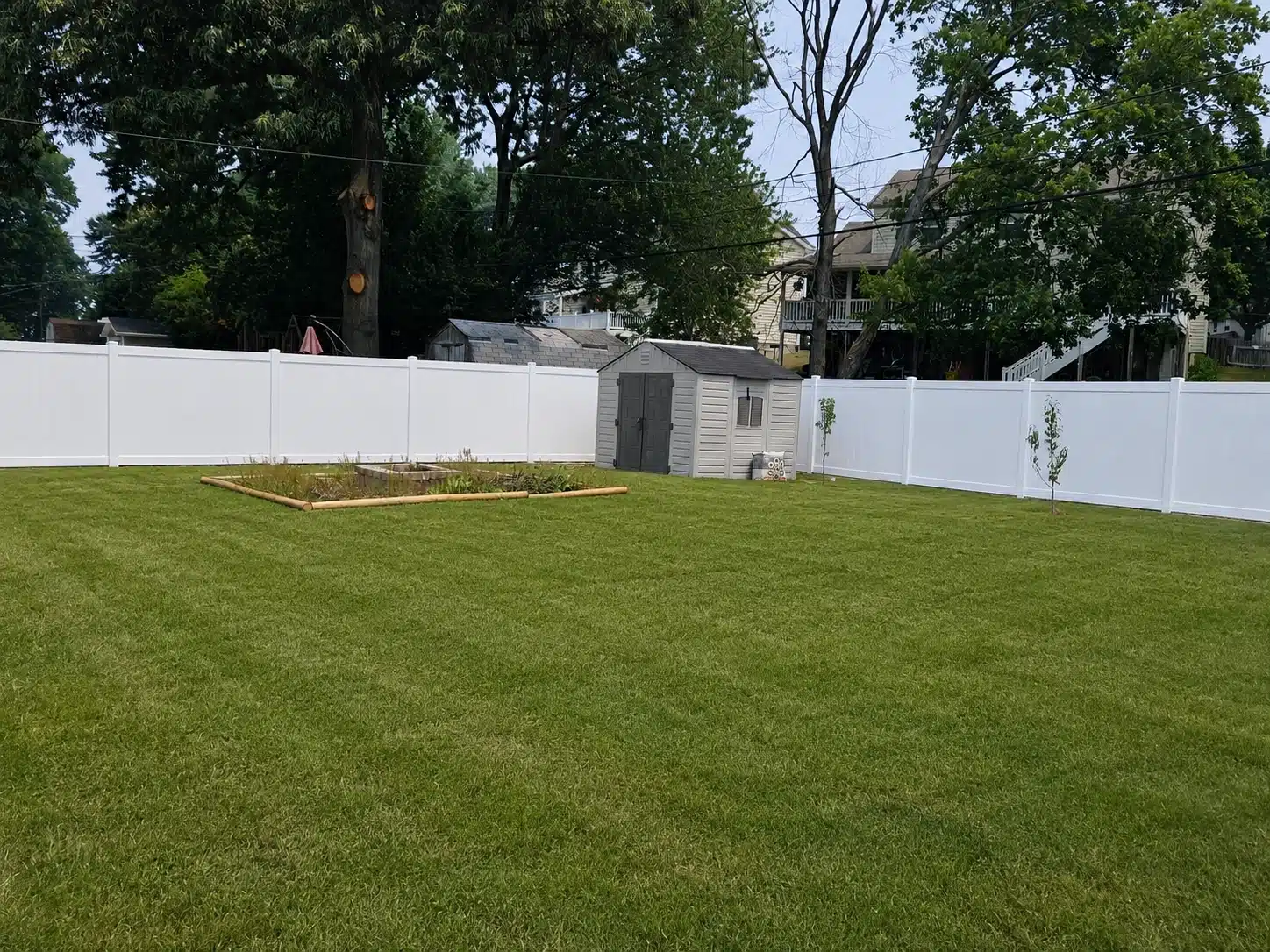 Backyard white vinyl fence with a shed for fence repair and replacement in Severna Park, MD.