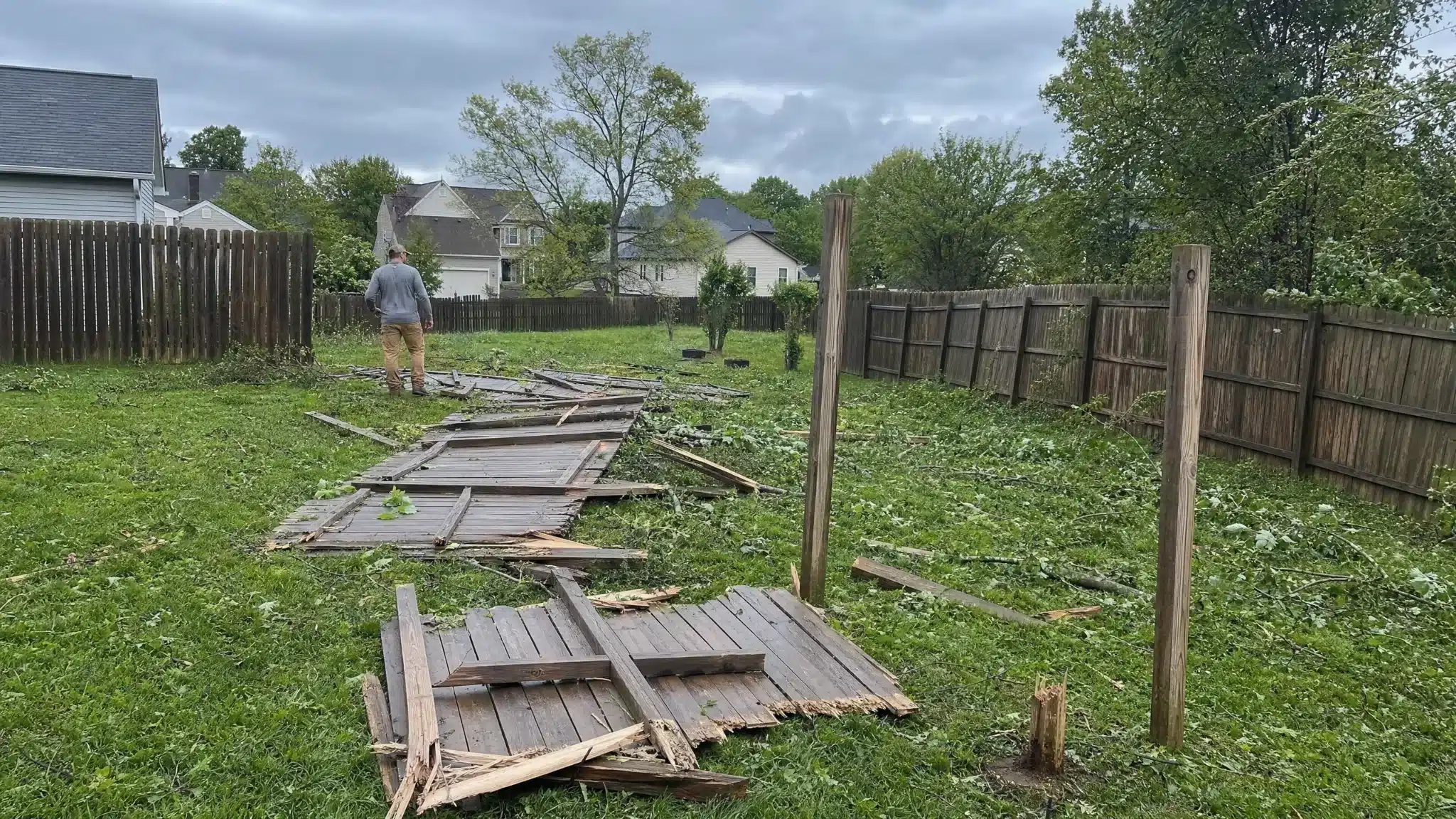 Storm-damaged wood fence panels removed from a backyard in Severna Park, MD.
