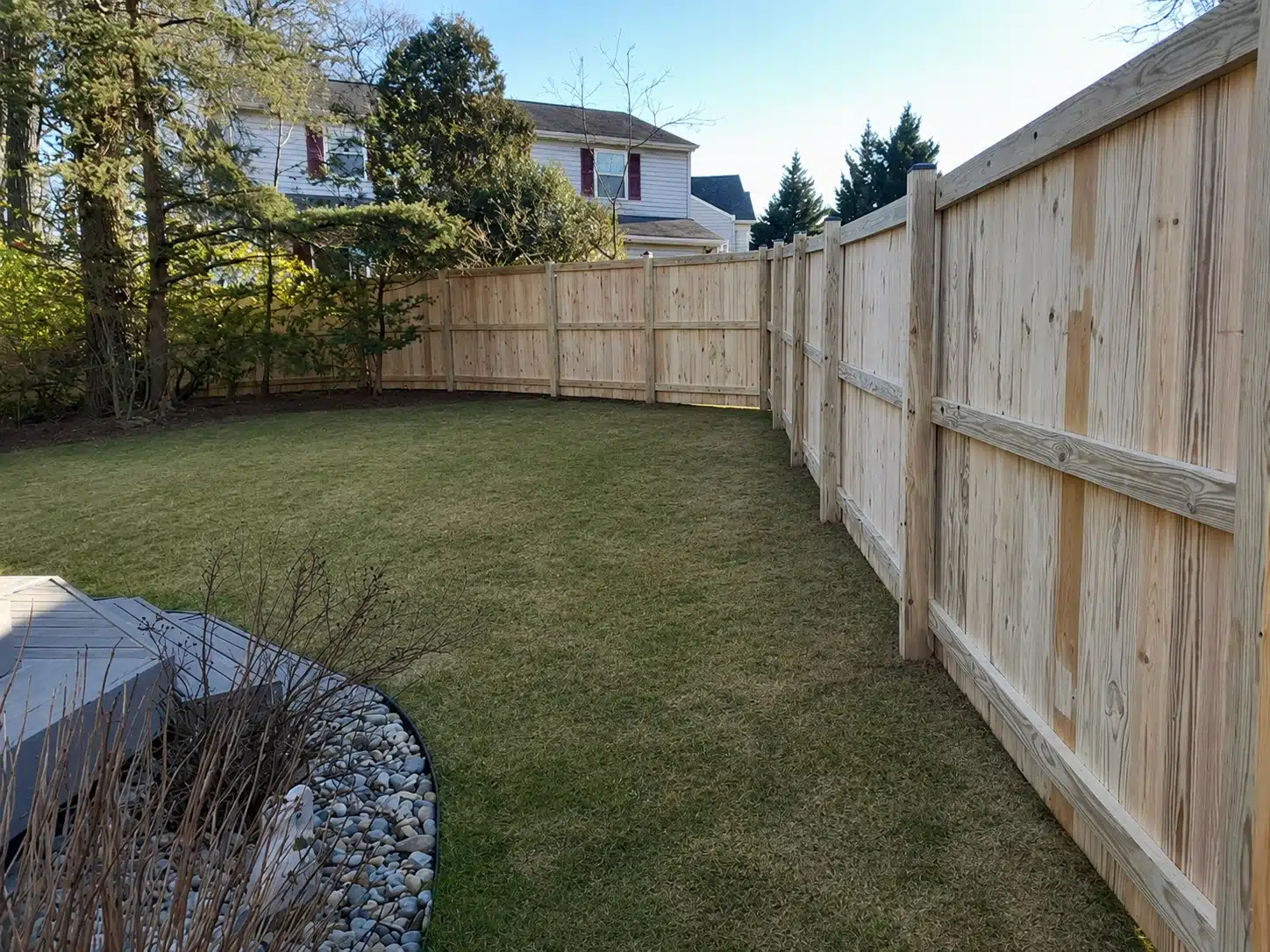 White vinyl corner yard fence for a residential property in Severna Park, MD.