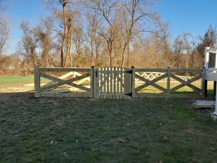 wood crossbuck fence installation with gate in Millersville Maryland