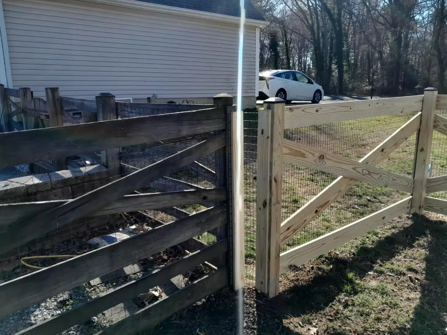 newly built crossbuck style wooden fence around a backyard in Millersville MD