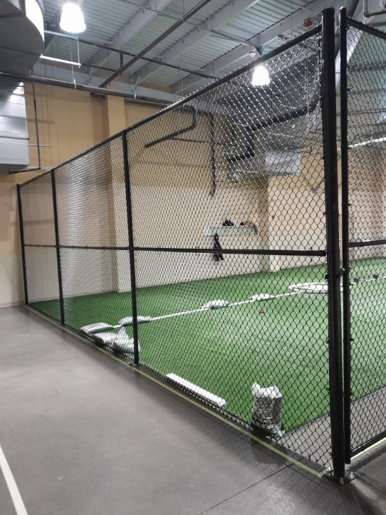 Indoor chain-link gates and fencing providing secure access inside Crofton athletic facility