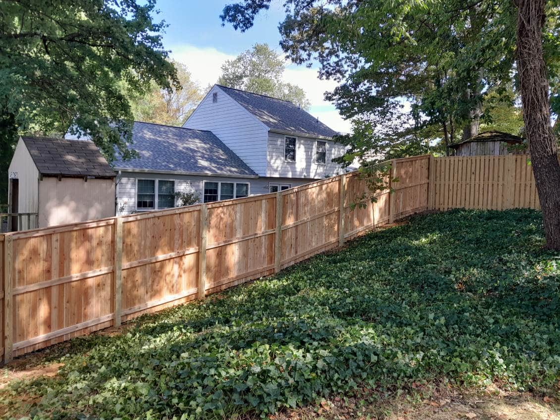 residential backyard with fresh cedar privacy fencing in Glen Burnie Maryland