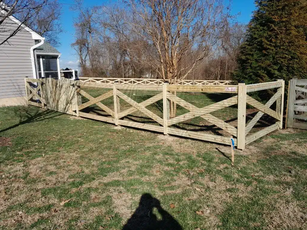 rustic wood crossbuck fencing providing yard enclosure in Millersville MD