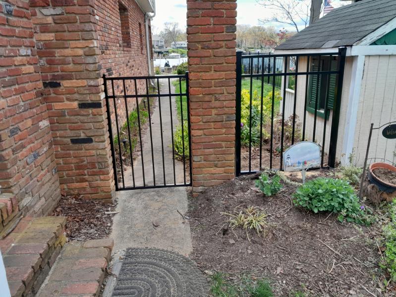 black aluminum gate between brick pillars at an Arnold Maryland home