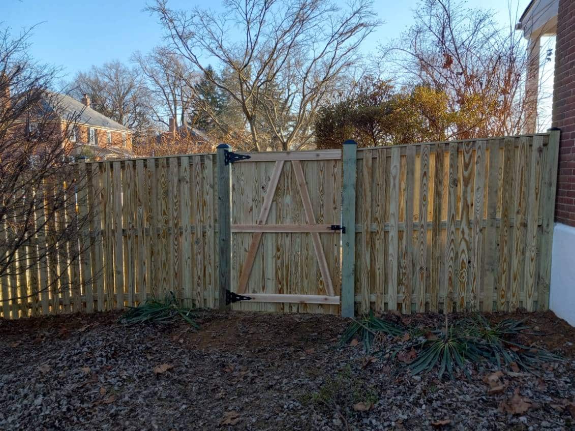 fresh pressure-treated wood fence surrounding a suburban yard in Pasadena Maryland