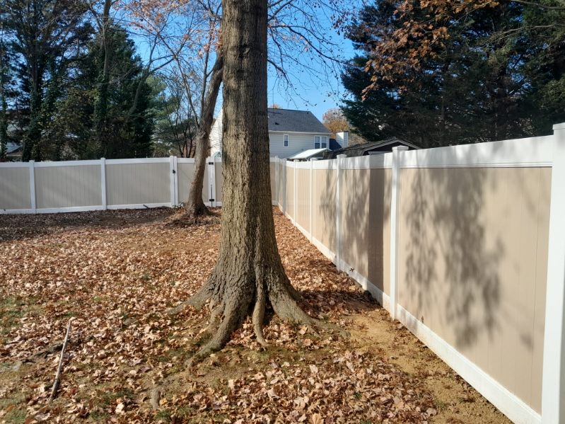 sturdy vinyl privacy fence installed along a wooded backyard in Odenton Maryland
