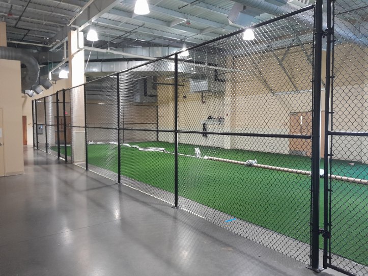 Secure indoor chain-link barrier installed along turf and concrete flooring in Crofton, Maryland