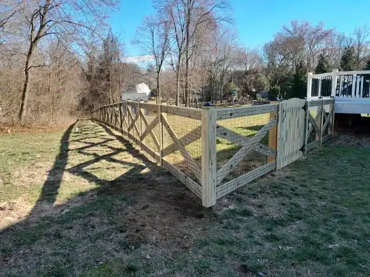backyard enclosed with crossbuck style wooden fencing in Millersville Maryland