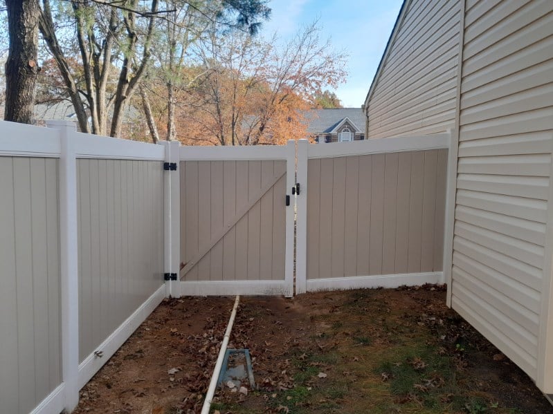 tan and white vinyl fence providing full privacy for an Odenton MD home