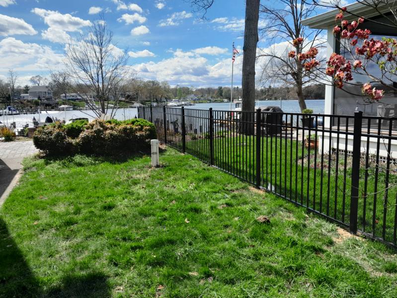 sleek black aluminum fence lining a grassy waterfront yard in Arnold Maryland