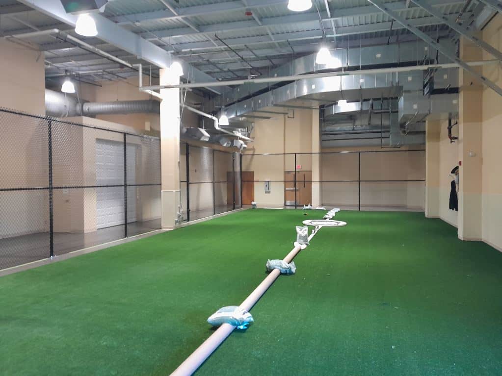 Indoor chain-link fence enclosure installed inside a turf sports facility in Crofton, MD