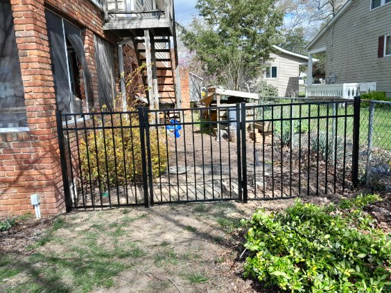 black aluminum double gate enclosing a backyard walkway in Arnold Maryland
