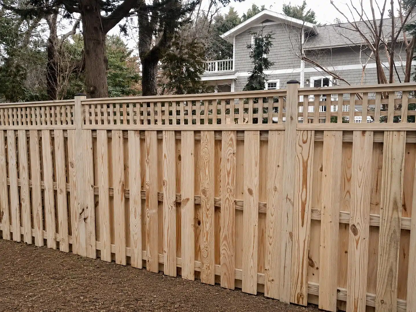 Pressure-treated shadowbox fence with a decorative lattice top installed in Pasadena, MD.