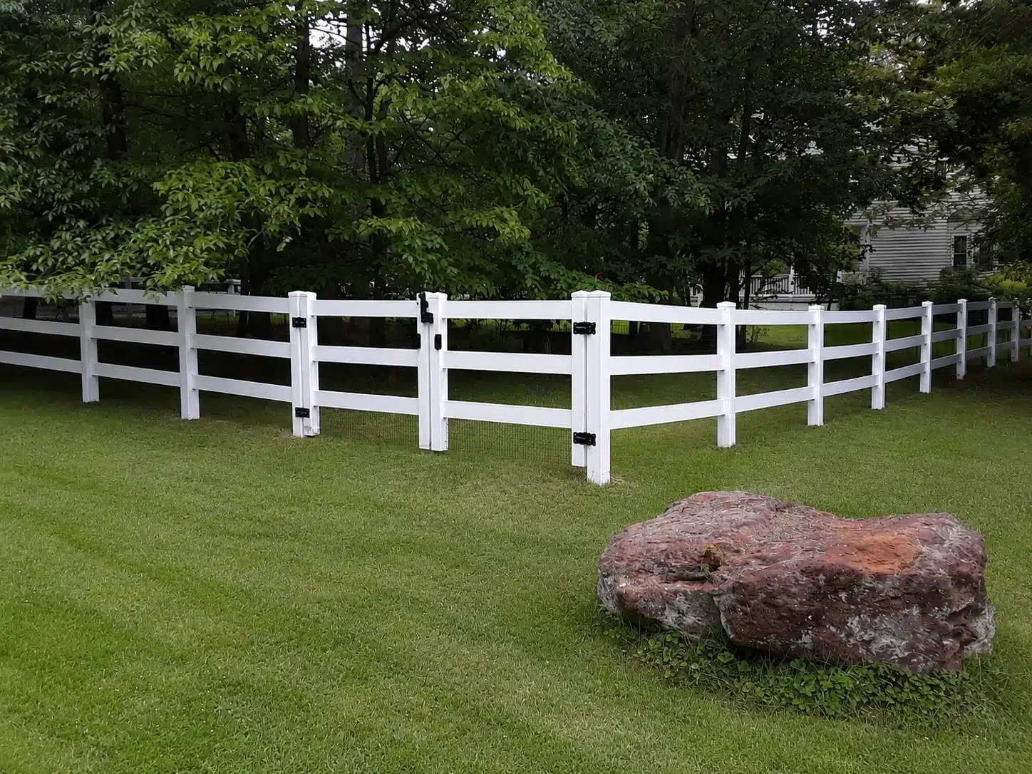 Ranch rail vinyl fence in a residential yard in Glen Burnie, MD.