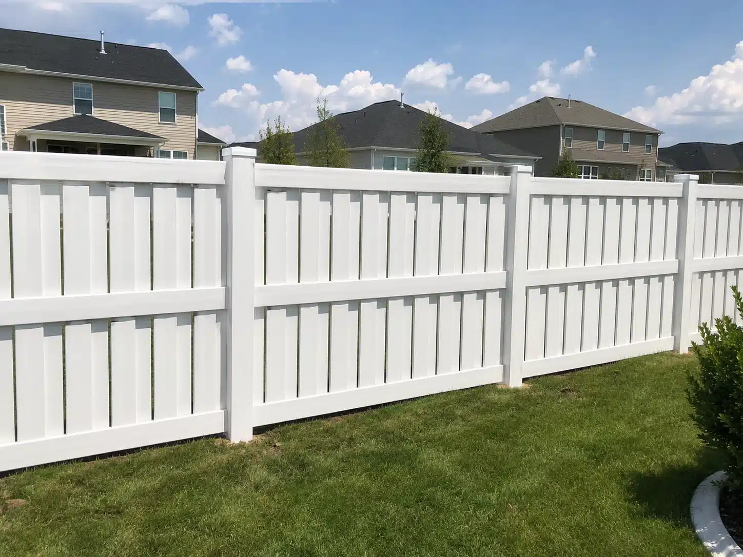 White shadowbox vinyl fence in a residential backyard in Glen Burnie, MD with clean vertical panels and suburban homes in the background.