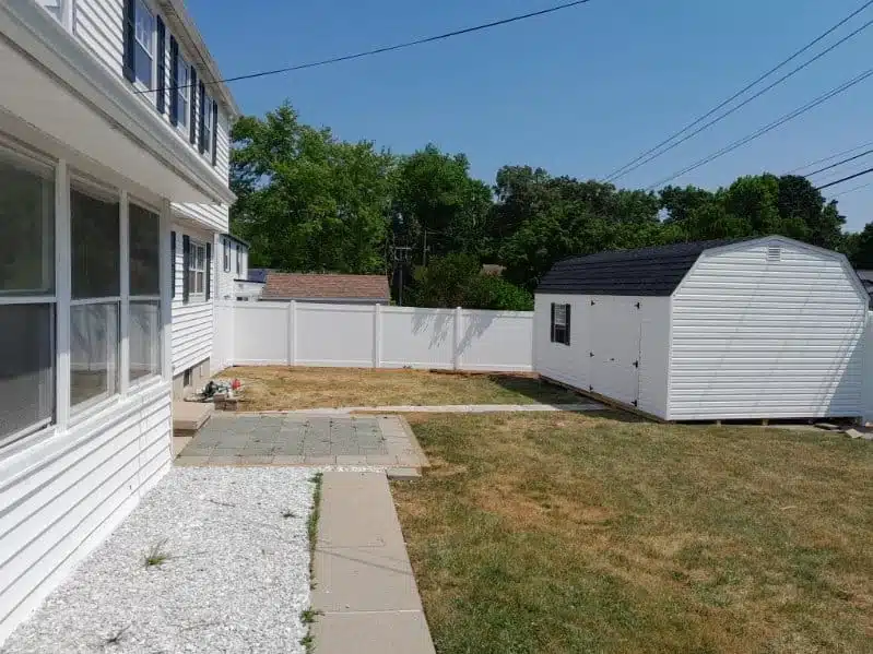 6-foot white vinyl privacy fence around a backyard with shed in Ferndale, MD