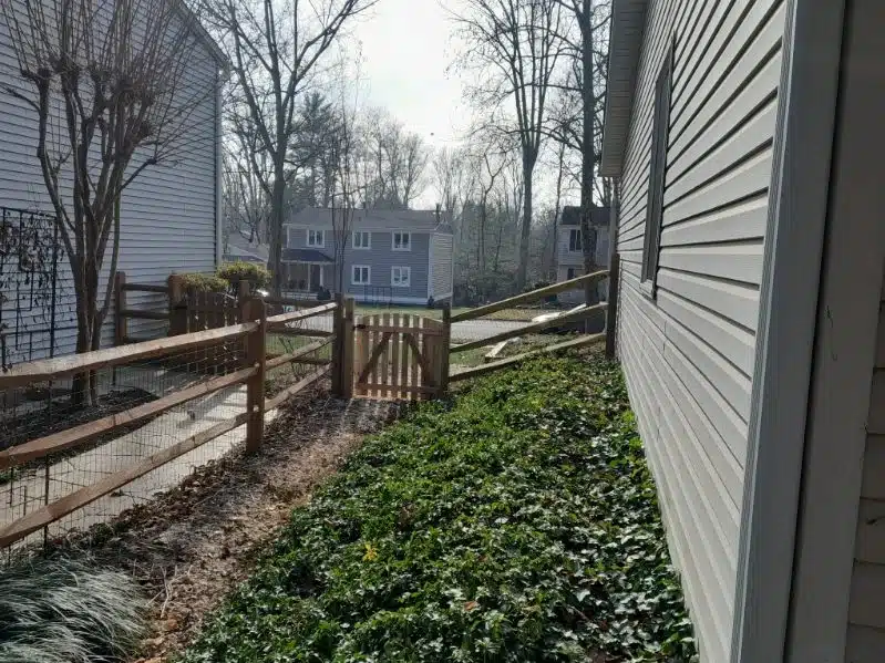 Split-rail fence with welded wire surrounding a residential yard in Crownsville, Maryland