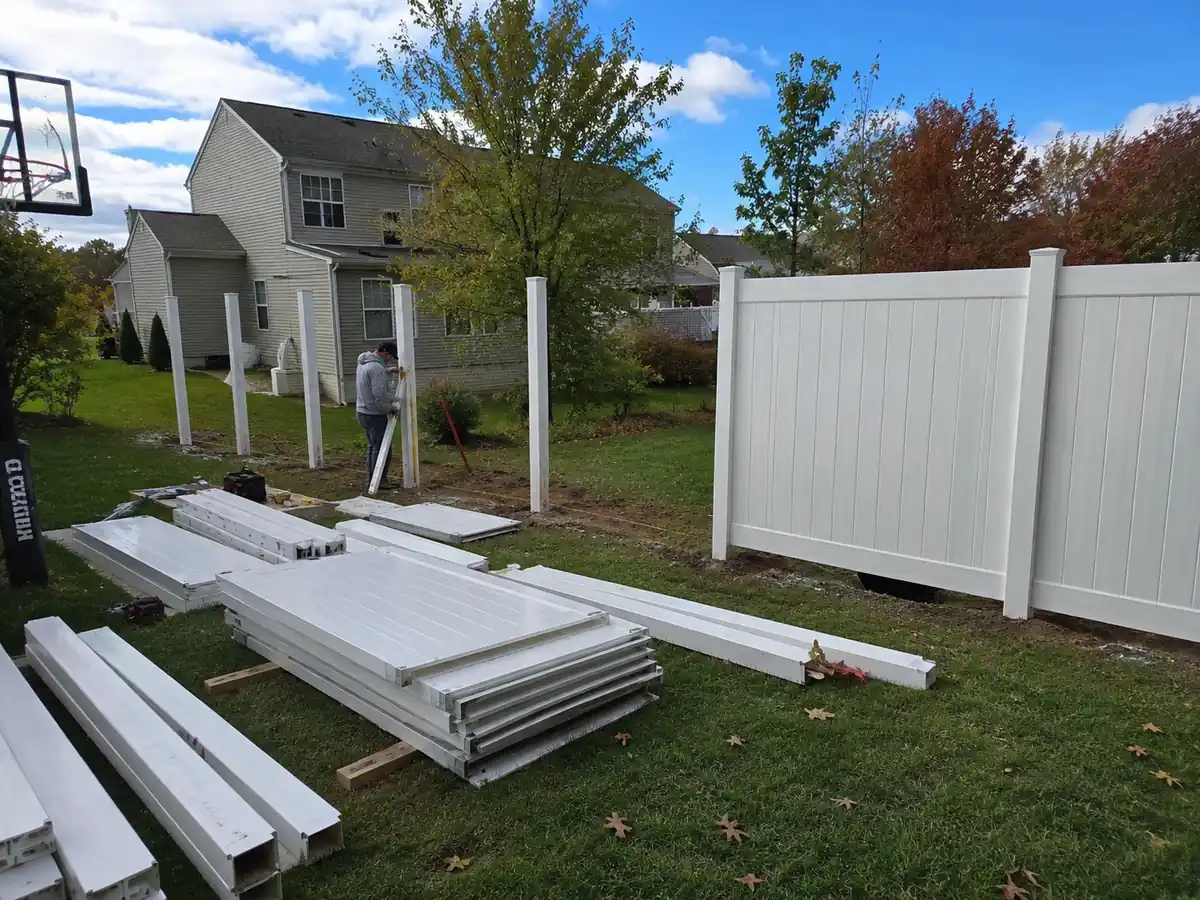 White vinyl fence installation in a Maryland backyard showing upfront material and labor costs