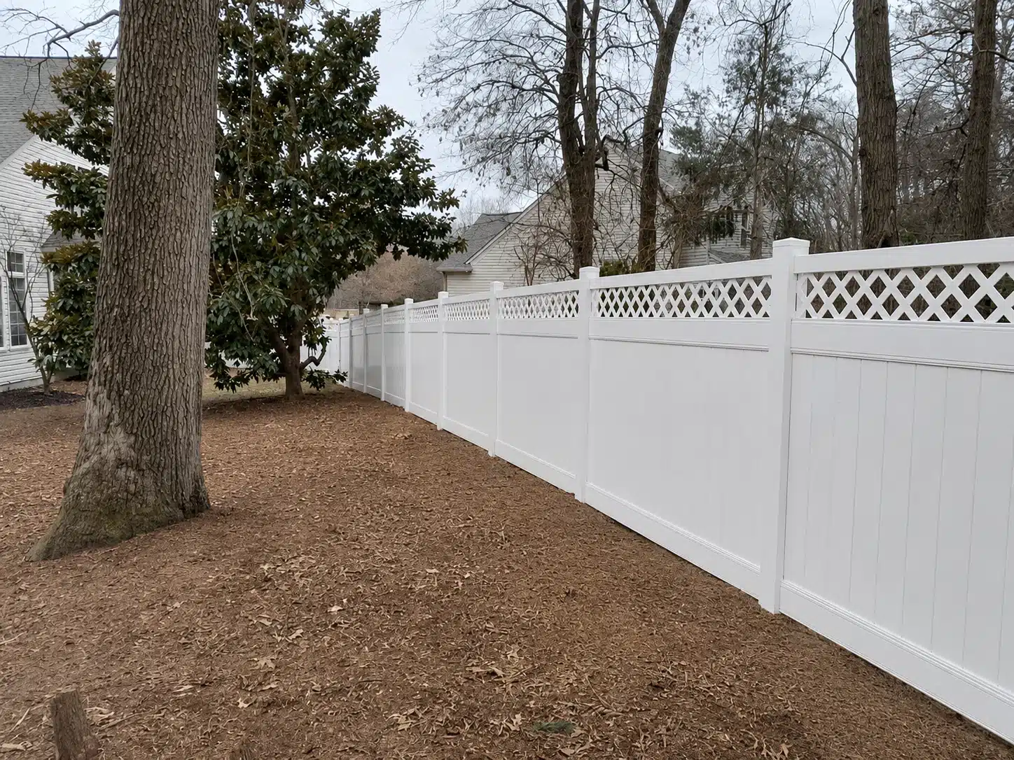White lattice-top vinyl privacy fence running along a residential backyard in Severna Park, MD.