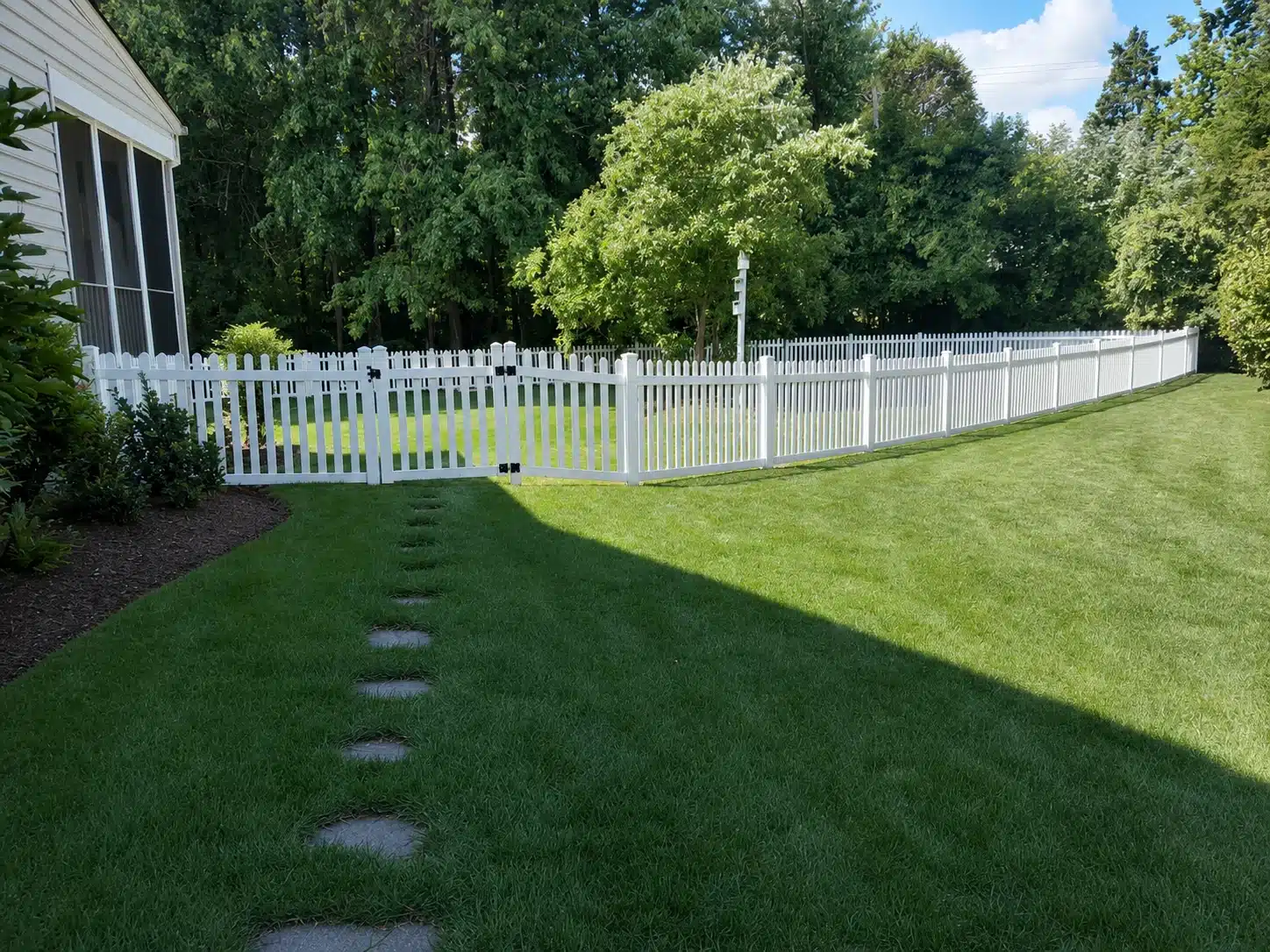 White vinyl picket fence enclosing a residential backyard in Glen Burnie, MD.
