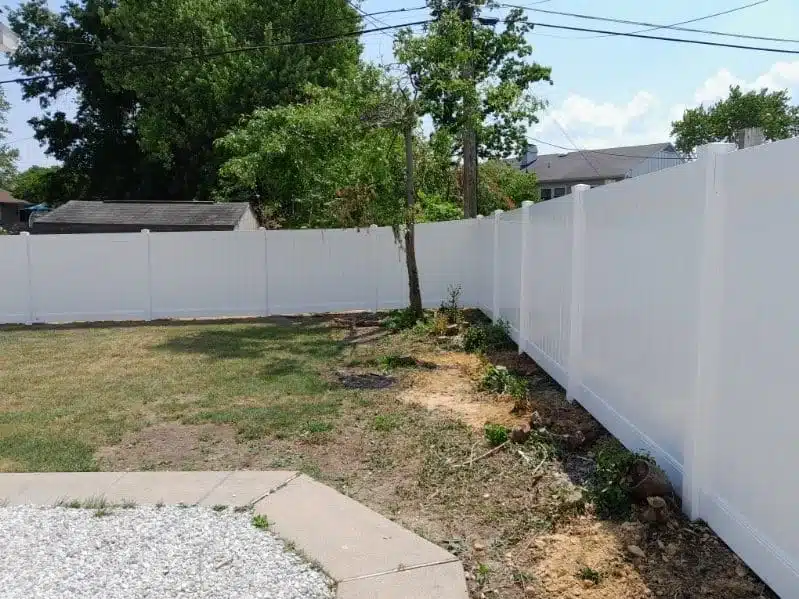 White vinyl privacy fence surrounding a residential backyard in Ferndale, MD