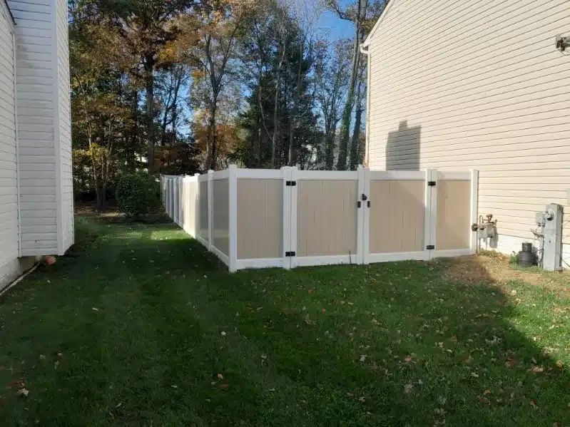 White vinyl privacy fence installed along a clean residential backyard in Severna Park, Maryland.