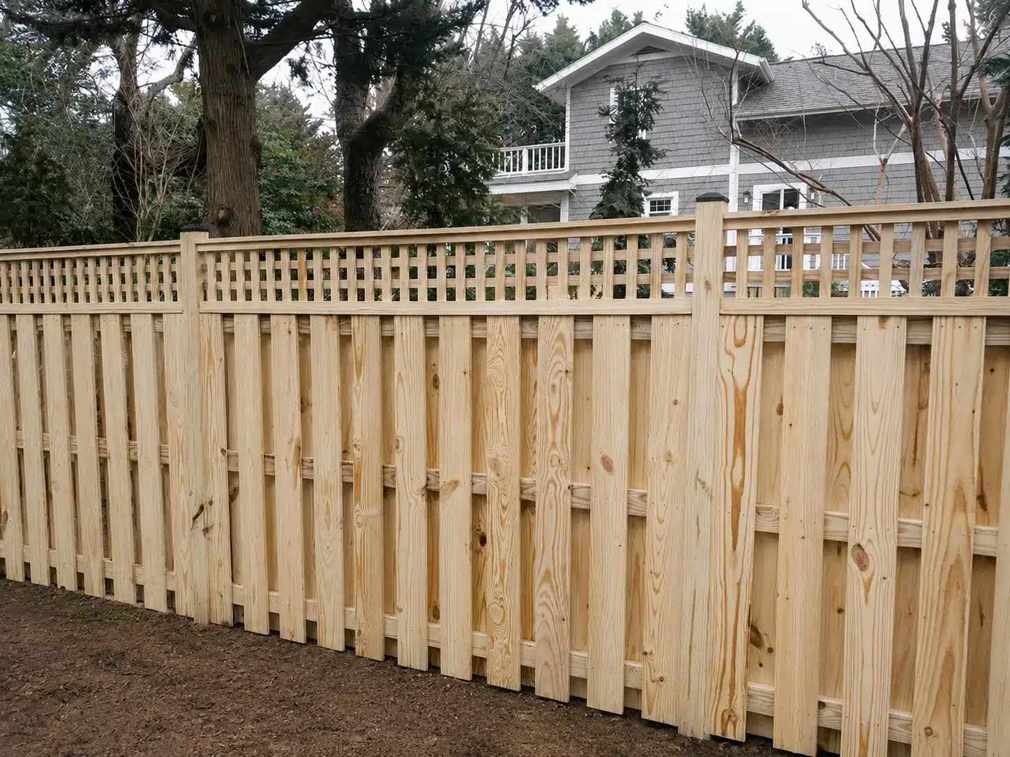 Wood privacy fence with a decorative lattice top installed in Severna Park, MD.