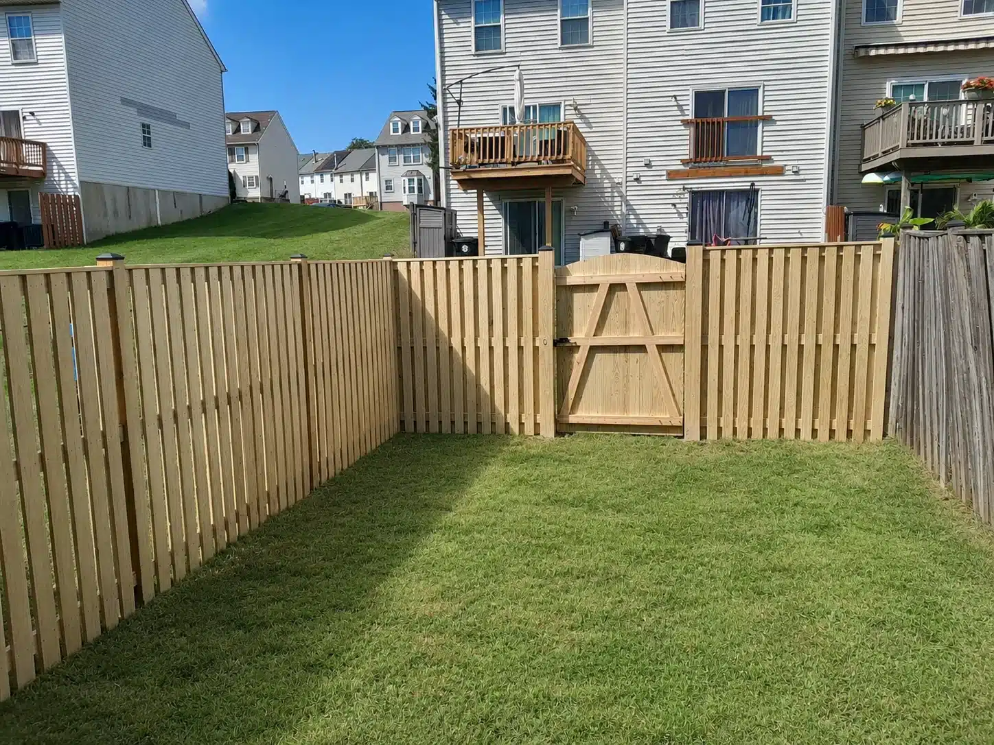 Wood picket fence with a matching single gate in a Severna Park, MD yard.