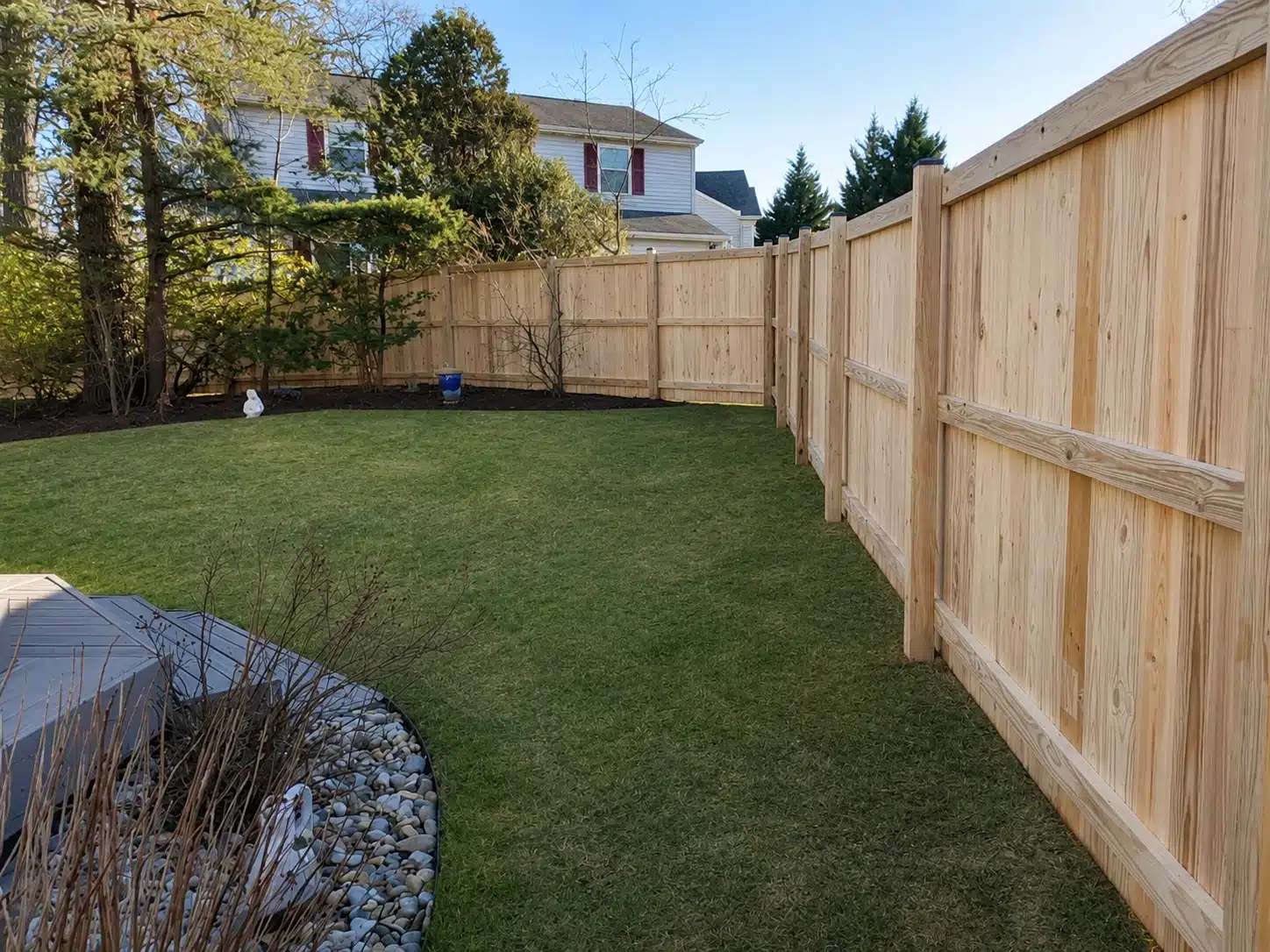 Vertical board wood privacy fence installed around a corner yard in Severna Park, MD.