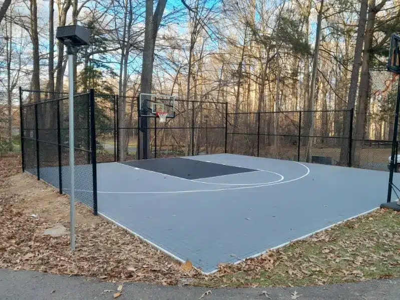 Chain link fence enclosing outdoor basketball court